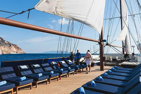 Race2Adventure Greece 2028 global vacation adventure deck view of galleon ship with a greek isle in the distance on a sunny day. Run, seek, adventure!