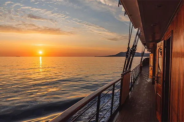Race2Adventure Greece 2028 global vacation adventure ocean sunset view from the side deck of a ship. Run, seek, adventure!