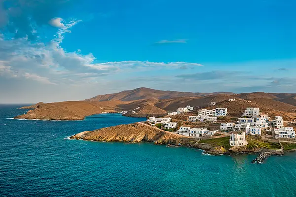 Race2Adventure Greece 2028 global vacation adventure aerial view of the greek island Kythnos surrounded by turquoise waters on a sunny day. Run, seek, adventure!